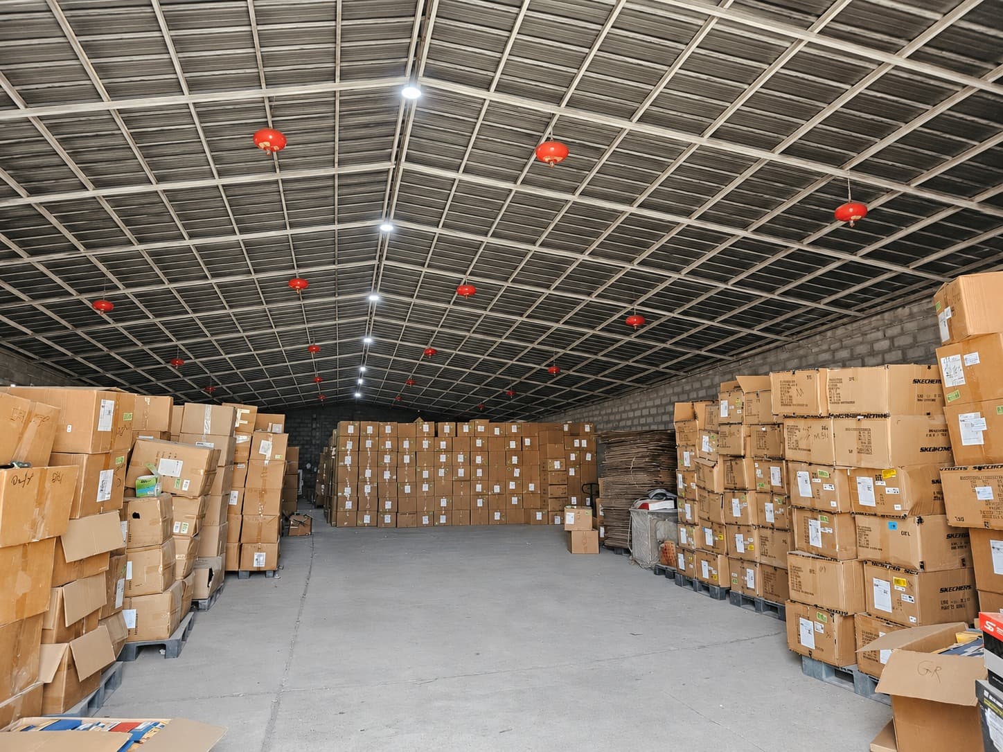 Amin Alsharq warehouse stacked with brand inventory on pallets